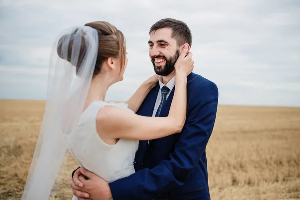 Wedding couple in love at wheat field with stubble. — Stock Photo, Image