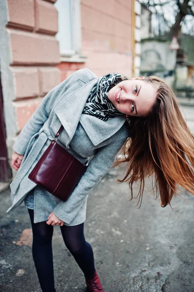 Young model girl in a gray coat with leather handbag on shoulder — Stock Photo, Image
