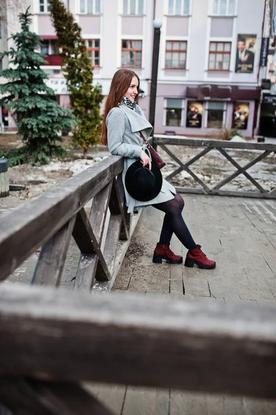 Young model girl in gray coat and black hat with leather handbag — Stock Photo, Image