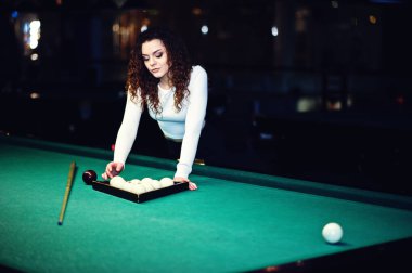 Genç kıvırcık kız Bilardo masası poz verdi. Seksi model siyah 