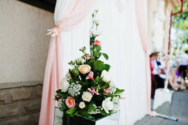 Bukett blommor på spegel kub mot bröllop arch på ceremo — Stockfoto