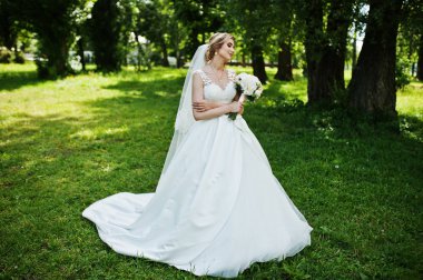 Sevimli sarışın gelin düğün buket güneşli Park ile.