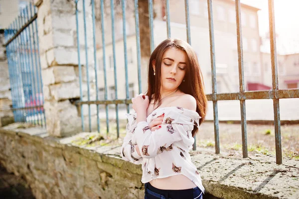 Young stylish brunette girl on shirt with cats and blue pants po — Stock Photo, Image