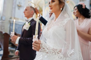 Boyuyla mumlar yanan ile kilisede Düğün çifti.