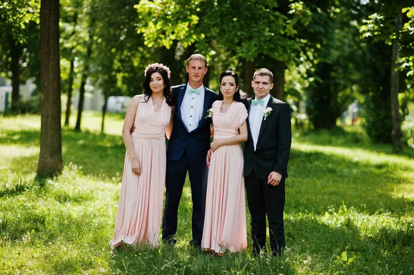 Best man\'s with bridesmaids on wedding at park.