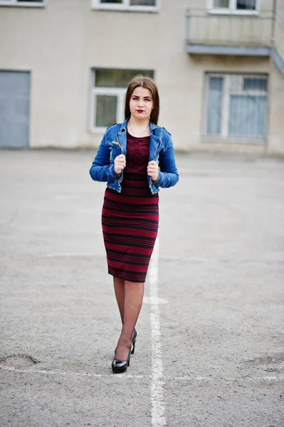 Young chubby teenage girl wear on red dress and jeans jacket pos