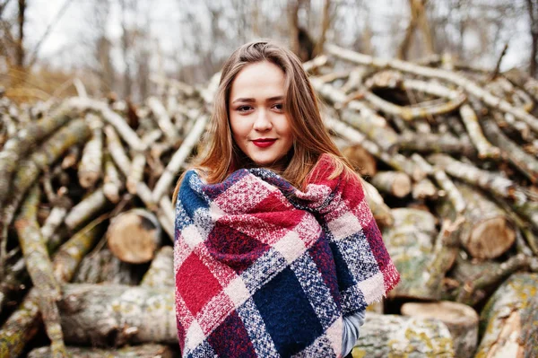 Young hipster girl wear on blanket against wooden stumps on wood — Stock Photo, Image