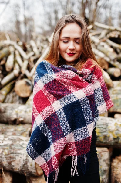 Junges Hipster-Mädchen trägt Decke gegen Holzstümpfe auf Holz — Stockfoto