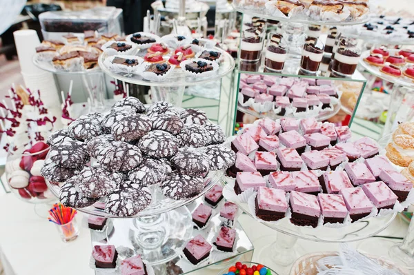 Wedding catering table with different sweets and cakes.