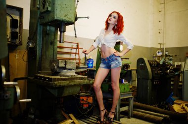 Kırmızı saçlı kız giyim kısa denim şort ve beyaz bluz poz