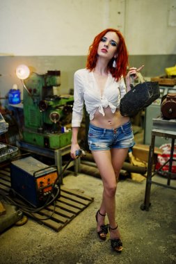 Kırmızı saçlı kız giymek kısa denim şort ve beyaz bluz ile