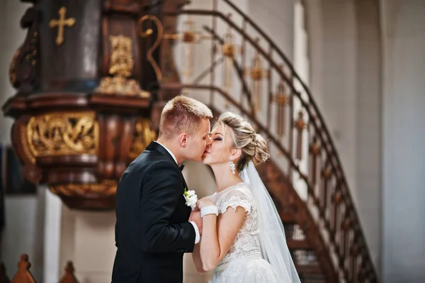 Fotosession av eleganta bröllop par på katolska kyrkan. — Stockfoto