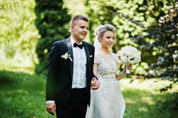 Casal de casamento elegante e lindo andando ao ar livre no parque em s — Fotografia de Stock