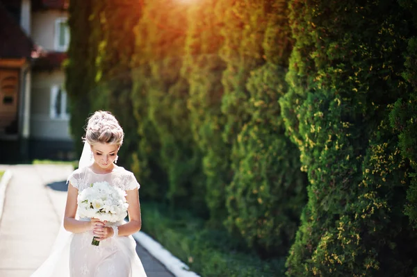 Impresionante hermosa novia rubia con ramo de boda en las manos en s — Foto de Stock