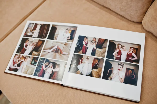 Two open pages of wedding book on sofa. — Stock Photo, Image