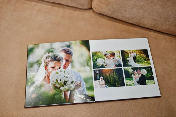 Two open pages of wedding book on sofa. — Stock Photo, Image