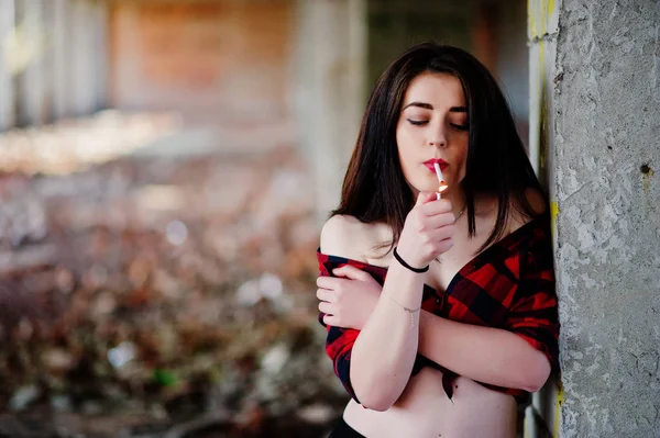 Portrait smoking girl with red lips wearing a red checkered shir — Stock Photo, Image