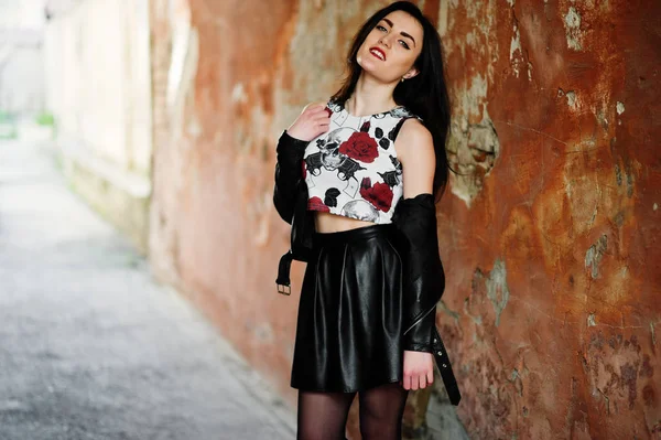 Jovem gótica na saia de couro preto e jaqueta contra grunge — Fotografia de Stock