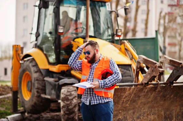 Brutal beard worker man suit construction worker in safety orang