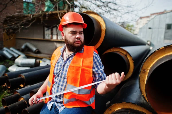 Brutal beard worker man suit construction worker in safety orang