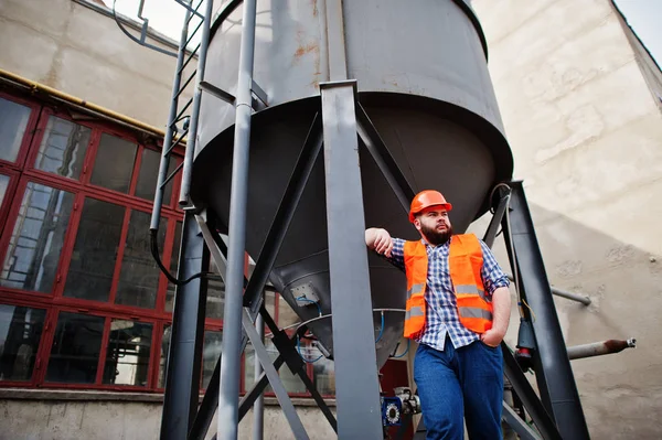 Brutal beard worker man suit construction worker in safety orang