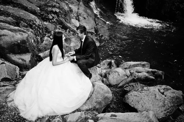 可爱的婚礼夫妇反对上日落在喀尔巴阡的瀑布 — 图库照片