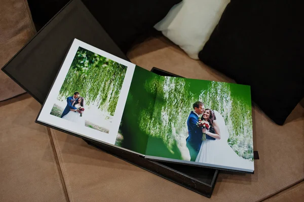 Open pages of brown luxury leather wedding book or album.