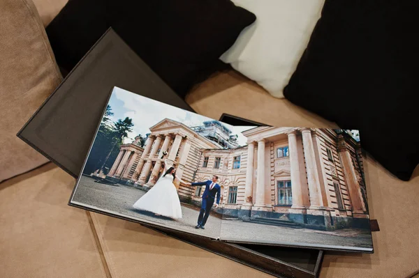 Open pages of brown luxury leather wedding book or album.