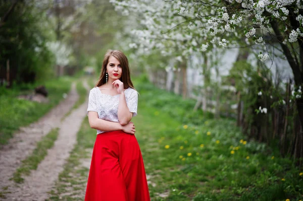 Retrato de menina bonita com lábios vermelhos na garde flor de primavera — Fotografia de Stock