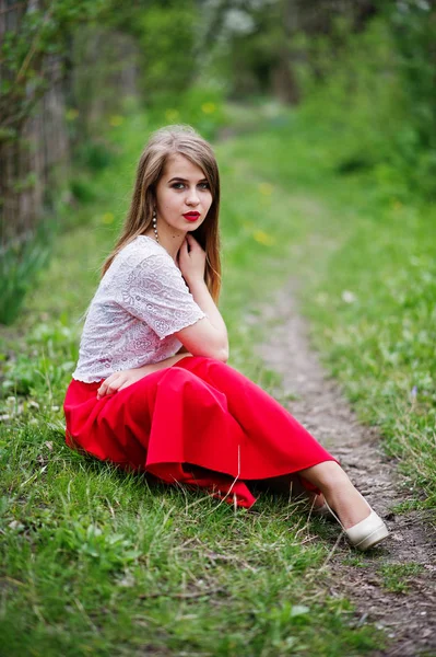 Ritratto di bella ragazza seduta con labbra rosse a fiore di primavera — Foto Stock