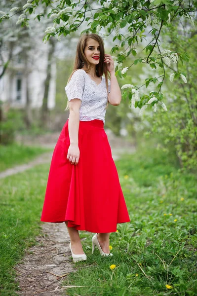 Portrait of beautiful girl with red lips at spring blossom garde — Stock Photo, Image