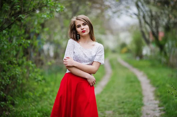 Portrait of beautiful girl with red lips at spring blossom garde — Stock Photo, Image