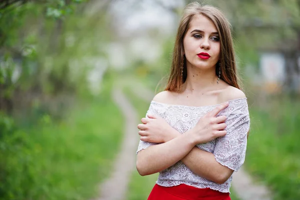 Portrait of beautiful girl with red lips at spring blossom garde — Stock Photo, Image