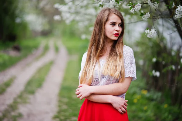 Portrait of beautiful girl with red lips at spring blossom garde — Stock Photo, Image
