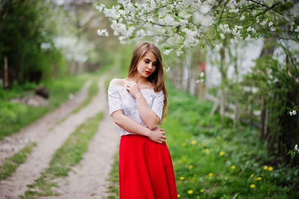 Portrait of beautiful girl with red lips at spring blossom garde — Stock Photo, Image