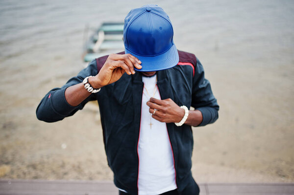 Portrait of stylish african american man on sportswear, cap and 