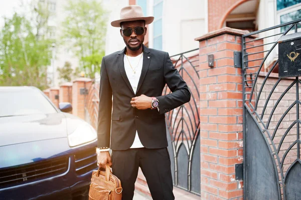 帽子とメガネでスタイリッシュな黒人男性をハンドバッグのスーツを着用します。 — ストック写真