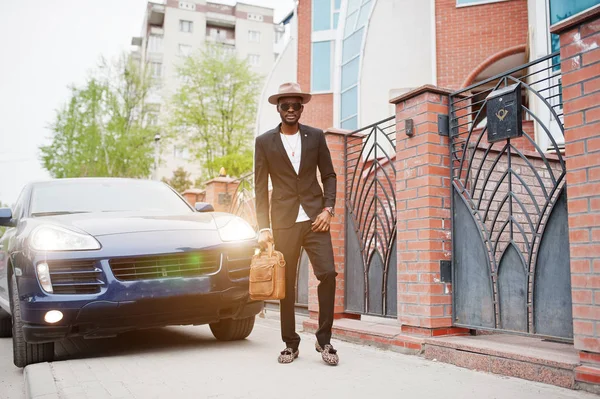 Stylish black man at glasses with hat, wear on suit with handbag