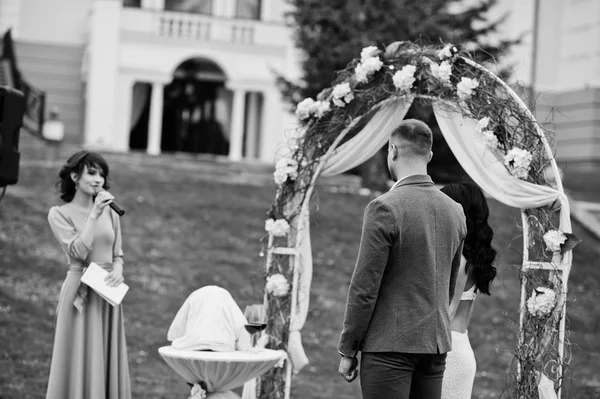 Young fashionable lovely couple with speech master of wedding ce — Stock Photo, Image