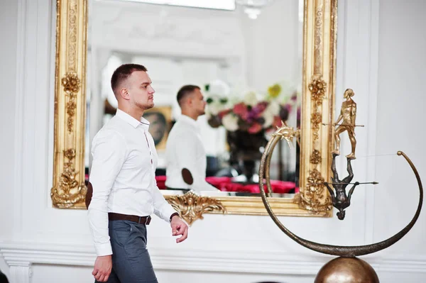 El hombre a la moda contra el espejo al vestido blanco palacete interior real — Foto de Stock