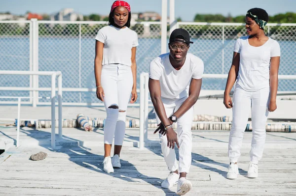 Three stylish african american friends, wear on white clothes at