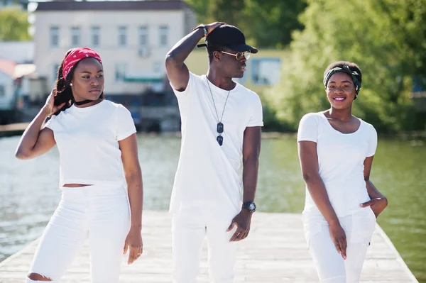 Three stylish african american friends, wear on white clothes. S