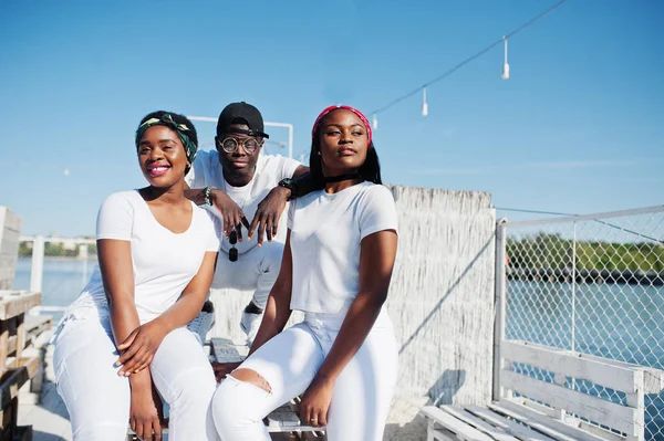 Drei stylische afrikanisch-amerikanische Freunde, tragen weiße Kleidung bei — Stockfoto