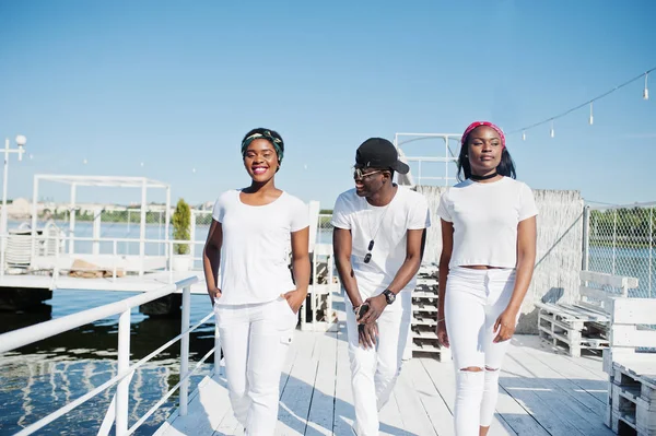 Three stylish african american friends, wear on white clothes at