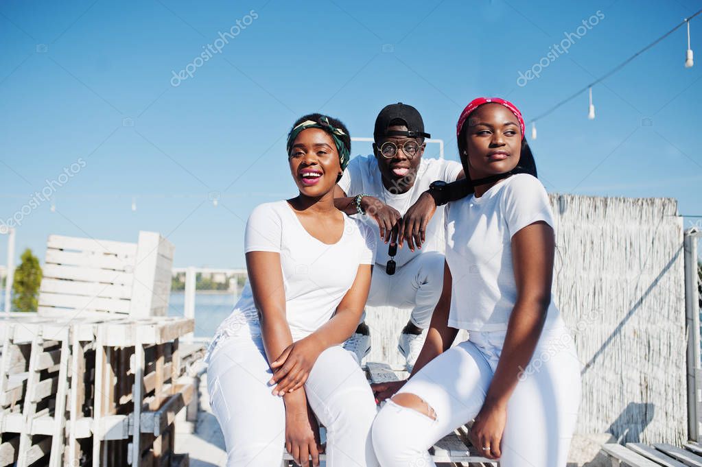 Three stylish african american friends, wear on white clothes at