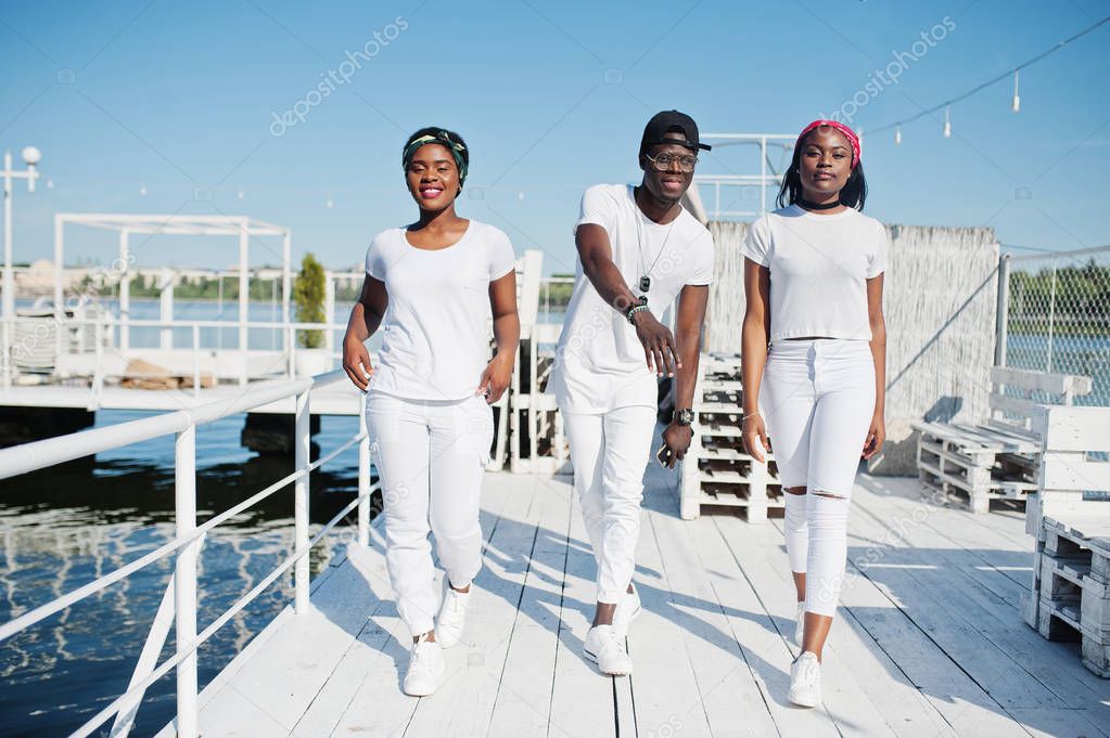 Three stylish african american friends, wear on white clothes at