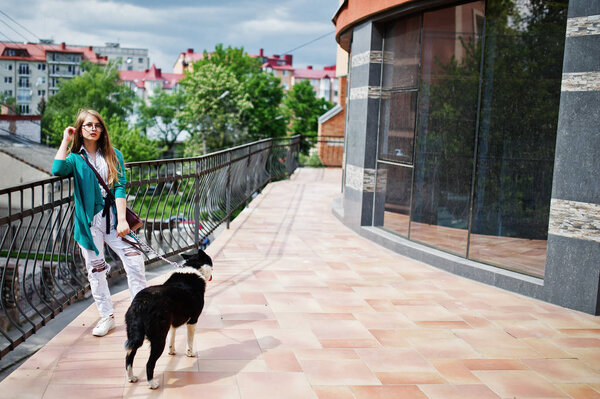 Trendy girl at glasses and ripped jeans with russo-european laik