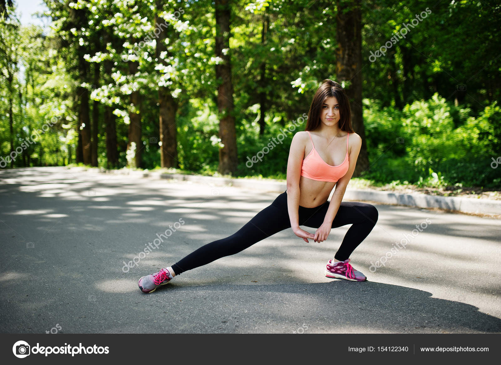 Fitness sport girl in sportswear doing stretching exercise in ro