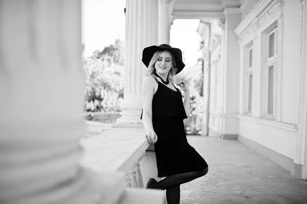Блондинка на черном платье, ожерелья и шляпа против винтажного h — стоковое фото