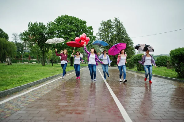 Group of six girls run and fun at hen party, with umbrella under — Stock Photo, Image